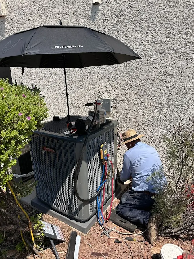 HVAC technician performing outdoor AC maintenance in Sallisaw